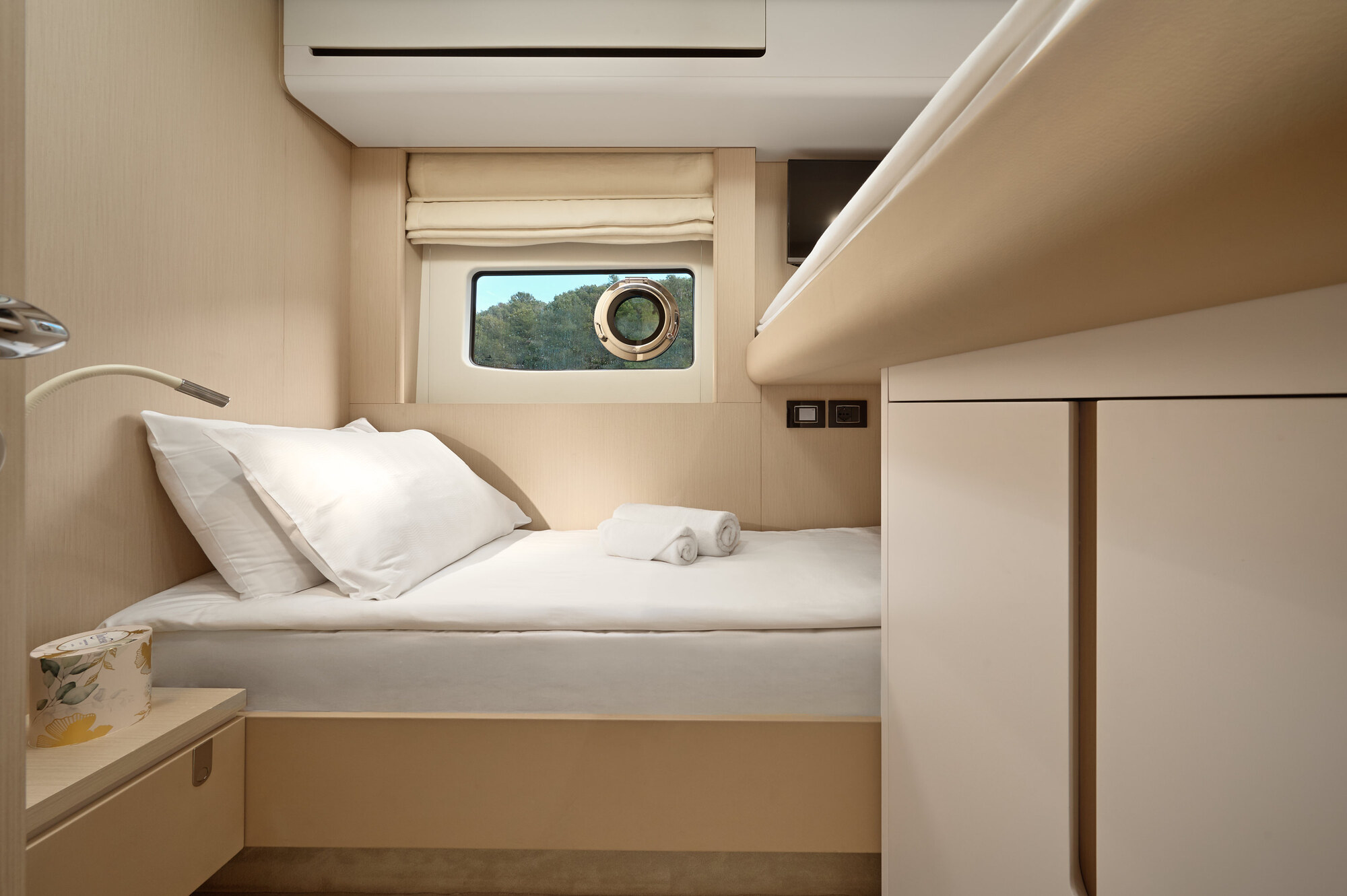 Double guest cabin with a double bed, a wardrobe and a hull window
