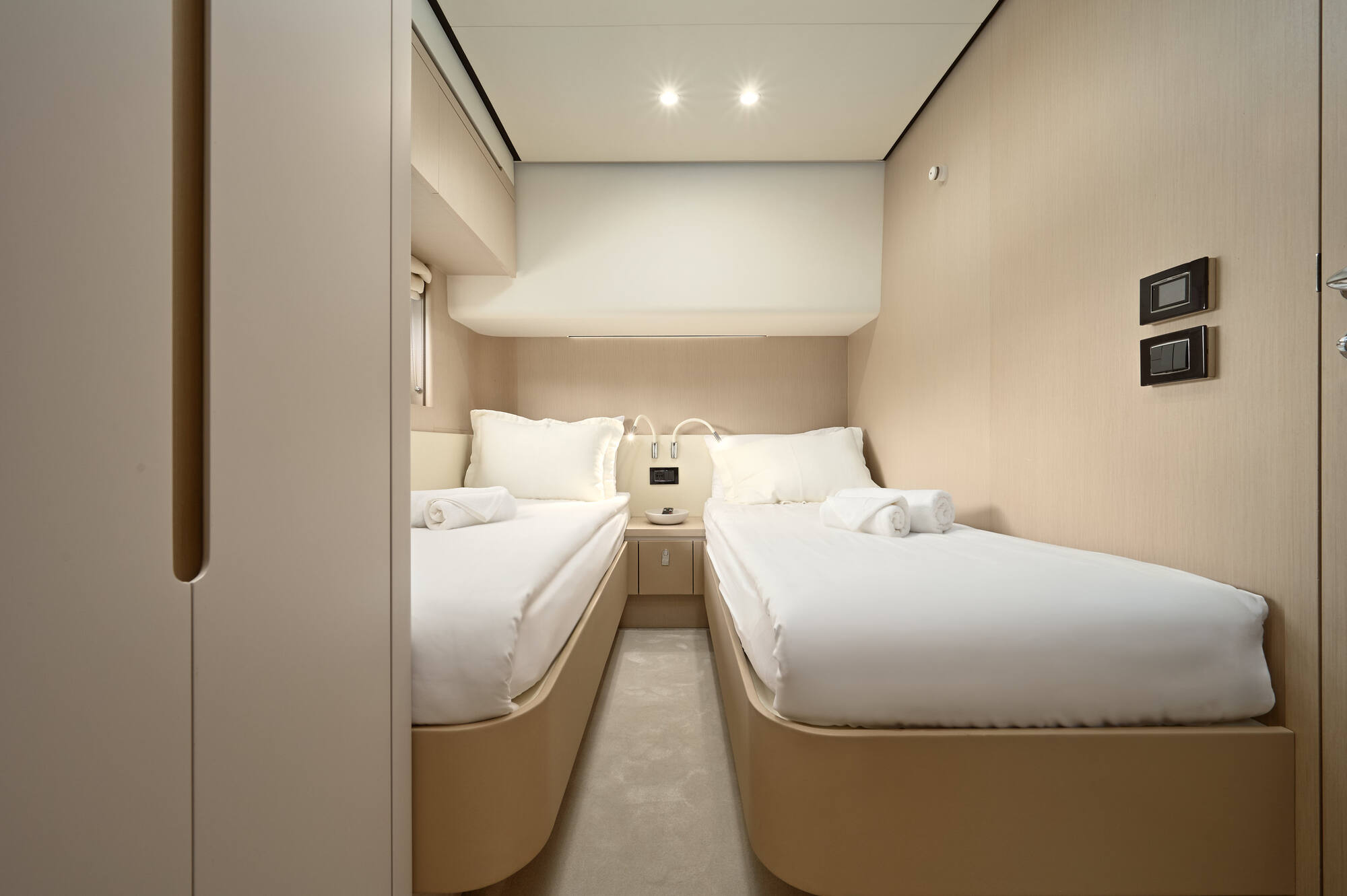 Twin guest cabin with two single beds either side of a shared nightstand